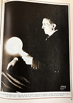Picture of Tesla holding a light bulb