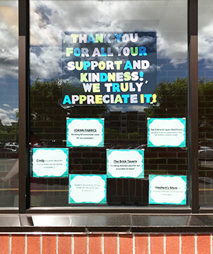 window with thank you notes for donations from local businesses
