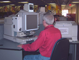 Man using a microfilm reader