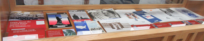 smaller display case with federal documents on topics related to immigration and citizenship