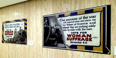 Two posters, emphasizing the work women were doing for the war (WWI), from the NYSOGS women's suffrage exhibit