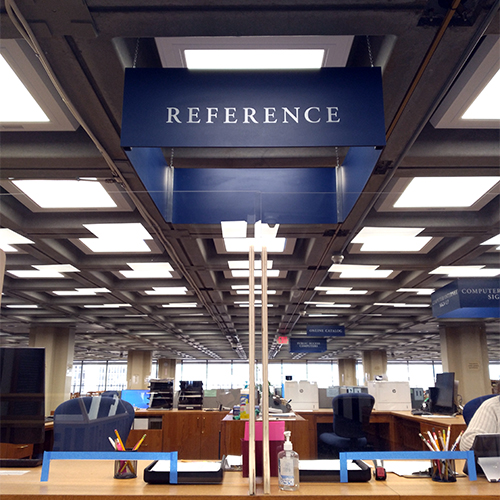 Front-facing view of the NYS Library Reference Desk on the 7th floor of the Cultural Education Center.