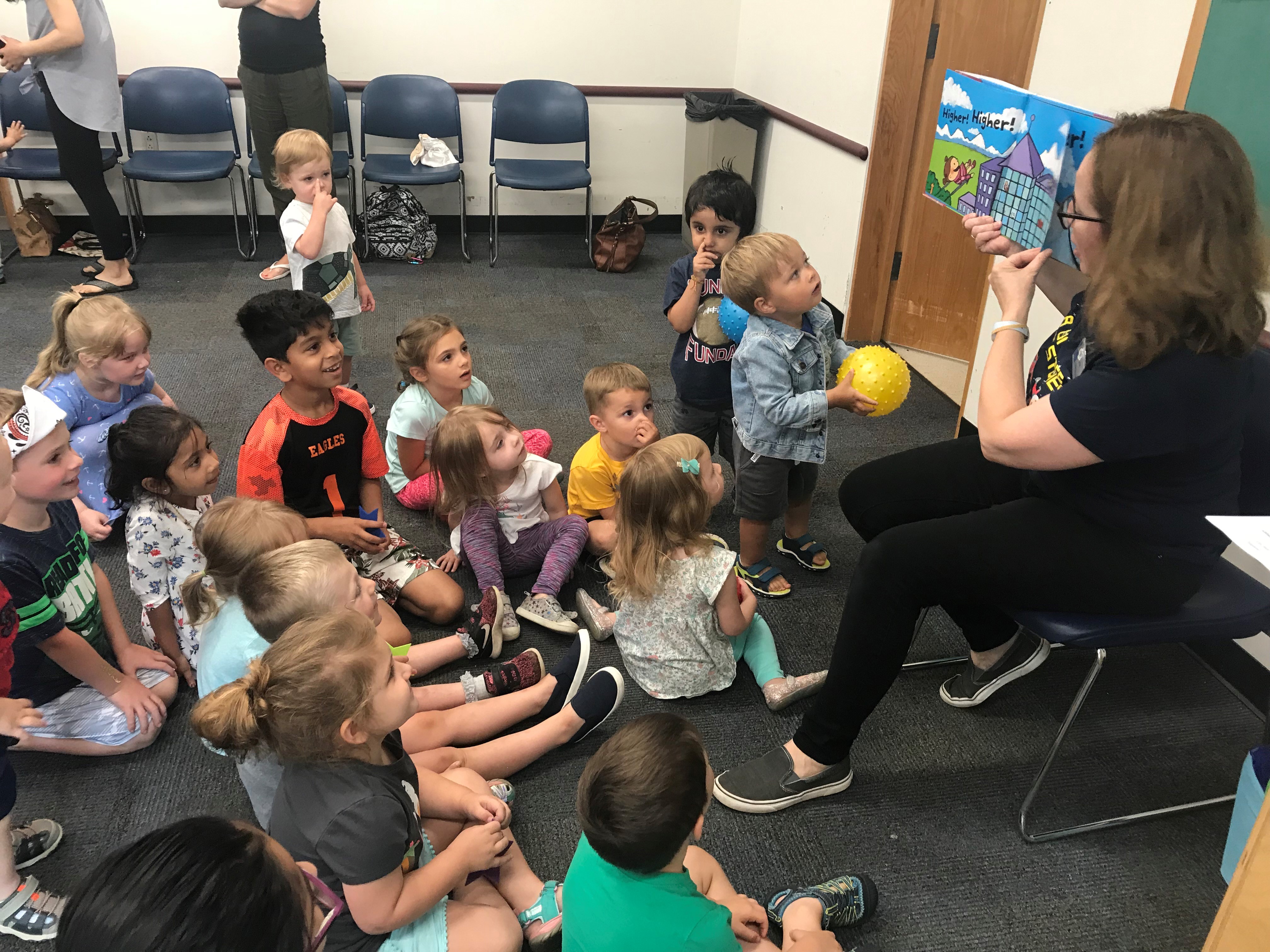 librarian reading to several young children