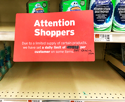 Sign on shelf of cleaning products limiting the number each customer can purchase to one per day.