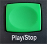 Title: Play/Stop Button - Description: Green rectangular play/stop button on the talking book player.